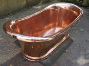 Polished copper roll top copper bath