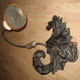 One of a pair of candle wall sconces with genuine carved wood and embossed steel strips