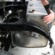Extra large Bentley Speed Six stainless steel fuel tank during construction in car, nearside top