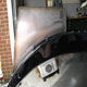 Extra large Bentley Speed Six stainless steel fuel tank during construction in car, offside