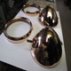 A pair of Lucas P100 Headlight bezels and bowls after copper polishing now ready for nickel plating